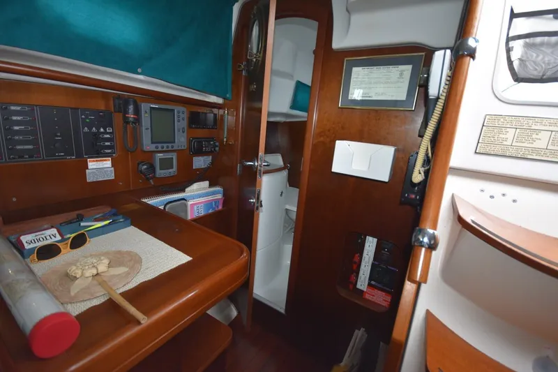 Slide: The Image of Interior of 1999 Beneteau Oceanis 36 CC sailboat with navigation equipment and wooden cabinetry. - 41