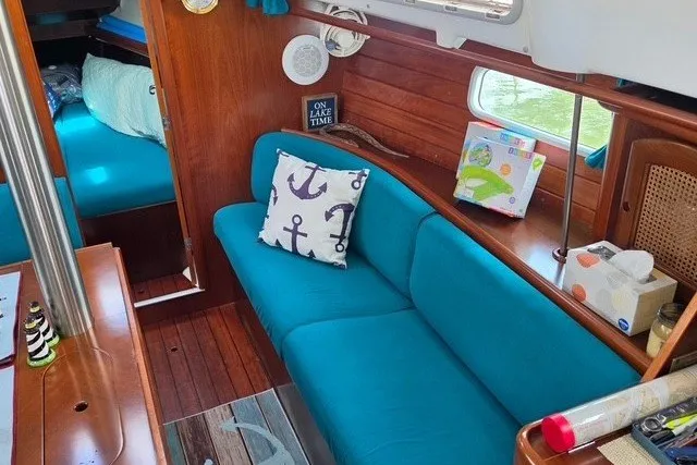 Slide: The Image of Interior of 1999 Beneteau Oceanis 36 CC sailboat with blue seating and nautical decor. - 24