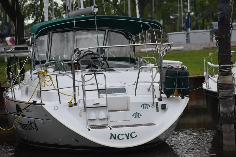 Slide: The Image of Beneteau Oceanis 36 CC sailboat, 1999 model, docked with green canopy and nautical equipment. - 54