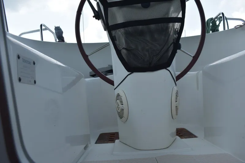 Slide: The Image of Cockpit view of a 1999 Beneteau Oceanis 36 CC sailboat, featuring steering wheel and seating. - 19