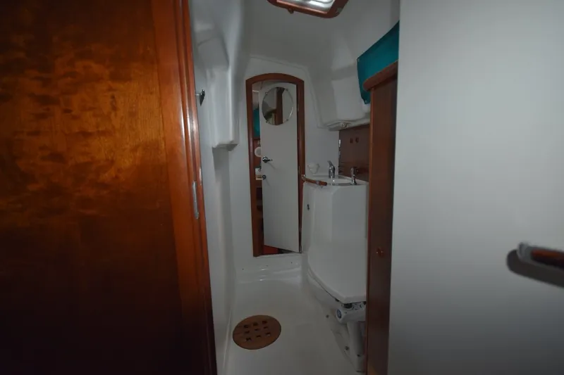 Slide: The Image of Interior of 1999 Beneteau Oceanis 36 CC yacht bathroom with wooden accents and compact design. - 35