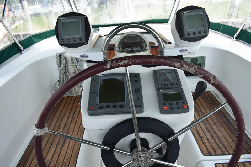Slide: The Image of Cockpit of 1999 Beneteau Oceanis 36 CC sailboat with navigation instruments and steering wheel. - 17