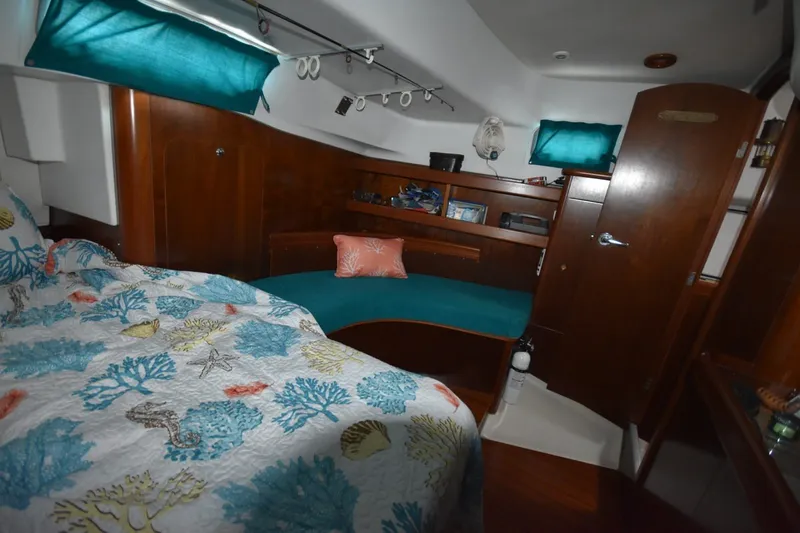 Slide: The Image of Cozy cabin interior of 1999 Beneteau Oceanis 36 CC with nautical-themed bedding. - 39