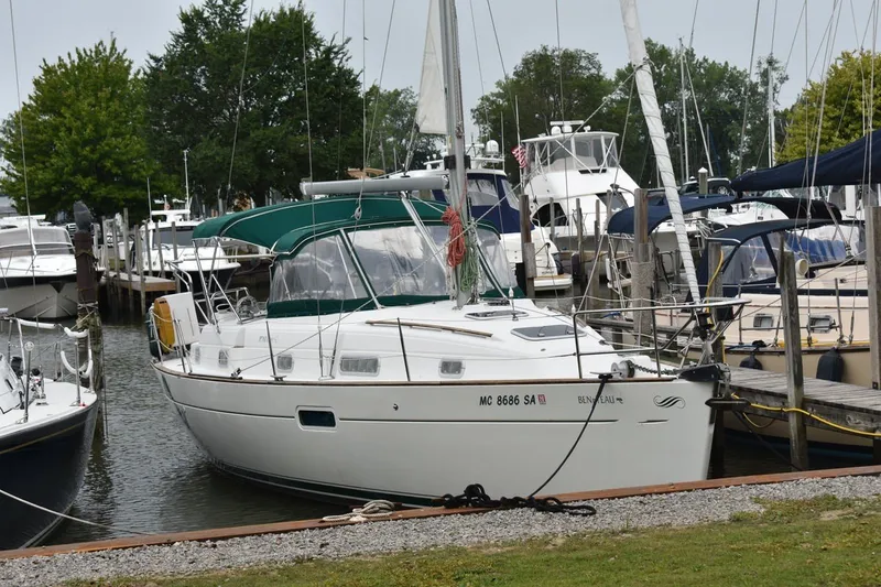 The Image of 1999 Beneteau Oceanis 36 CC sailboat docked in a marina, surrounded by other boats. - 0