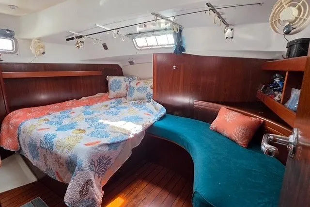Slide: The Image of Cozy cabin interior of 1999 Beneteau Oceanis 36 CC with colorful bedding and seating. - 37