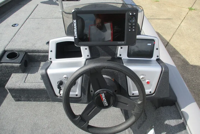 Slide: The Image of 2027 Tracker Pro Team 175 boat dashboard with steering wheel and Lowrance fishfinder. - 4