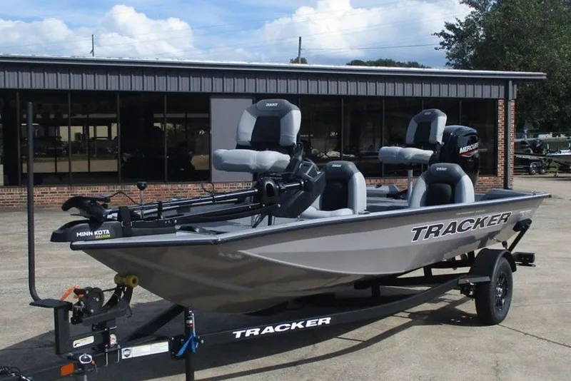 Slide: The Image of 2027 Tracker Pro Team 175 boat with trailer, parked outdoors, featuring Minn Kota motor. - 10
