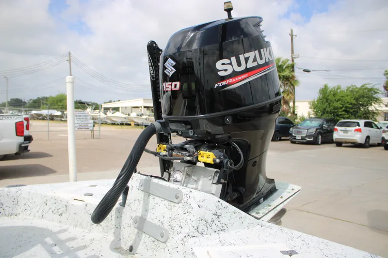 Slide: The Image of 2018 Shallow Stalker 204 RC boat with Suzuki 150 outboard motor in a parking lot. - 6