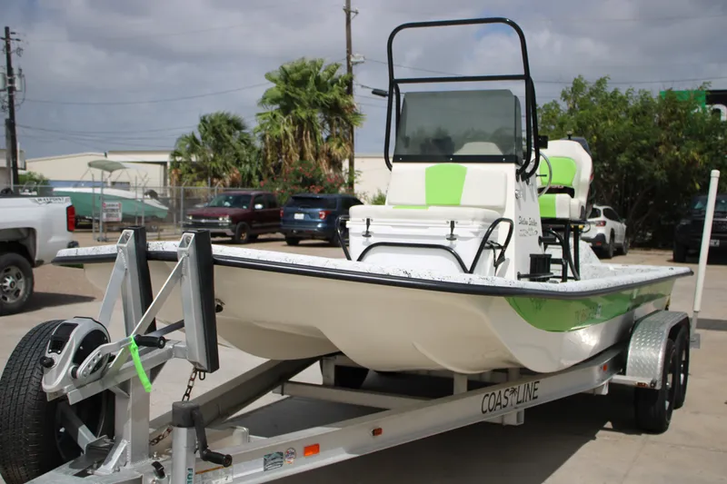 Slide: The Image of 2018 Shallow Stalker 204 RC boat on trailer, parked outdoors, featuring green and white design. - 15