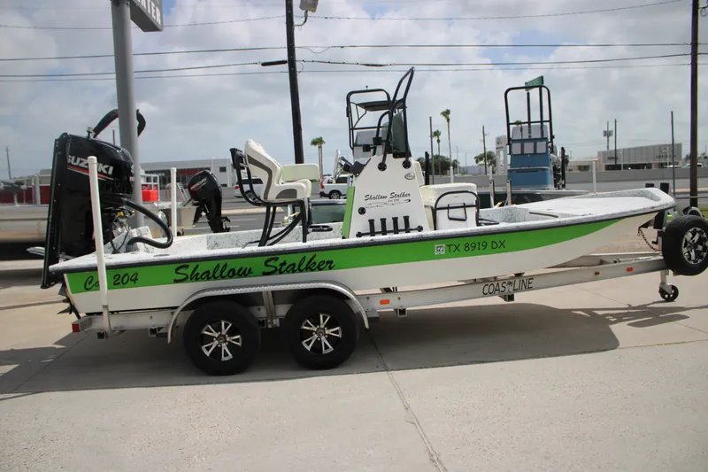 Slide: The Image of 2018 Shallow Stalker 204 RC boat on trailer, featuring Suzuki outboard motor. - 1