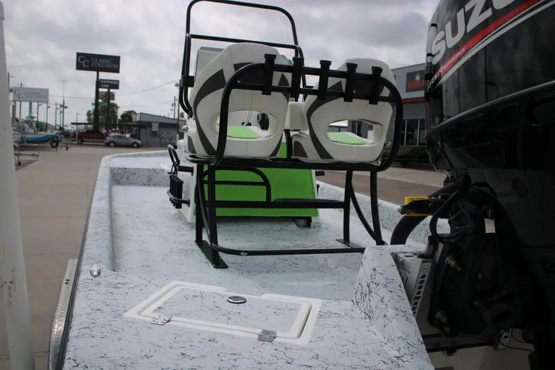 Slide: The Image of 2018 Shallow Stalker 204 RC boat with Suzuki outboard motor, parked outdoors. - 4