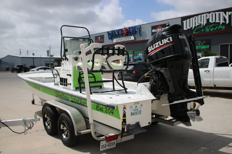 Slide: The Image of 2018 Shallow Stalker 204 RC boat with Suzuki engine on trailer, parked outside dealership. - 17