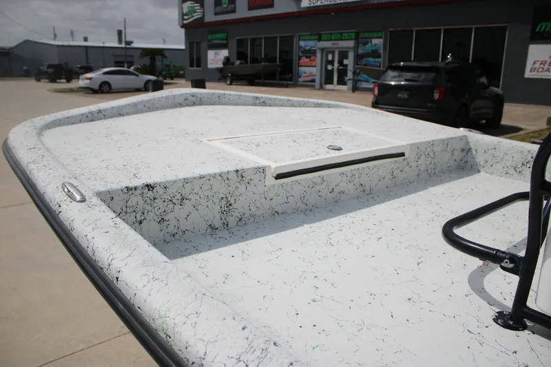 Slide: The Image of 2018 Shallow Stalker 204 RC boat deck with speckled finish, parked outside dealership. - 8