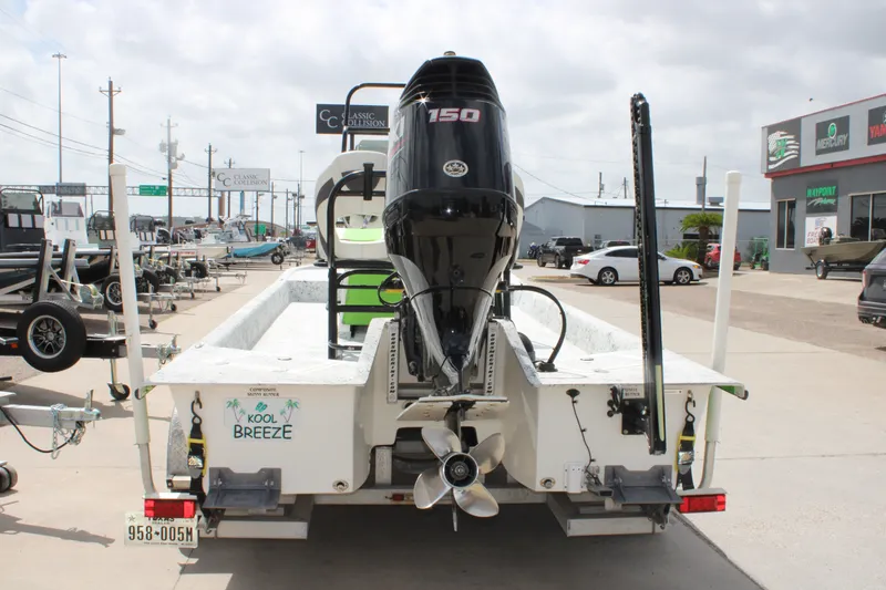 Slide: The Image of 2018 Shallow Stalker 204 RC boat with 150 HP engine, parked at a dealership. - 16