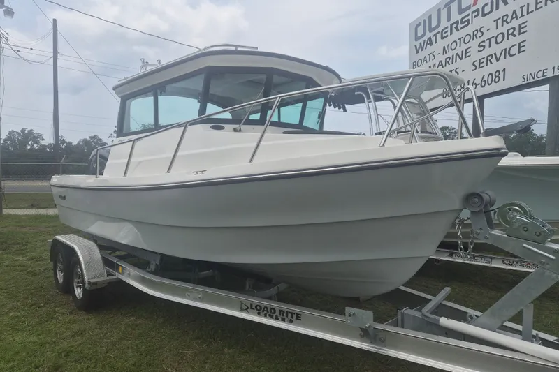 The Image of 2027 Arima Sea Ranger 21 Yellowtail Edition boat on trailer, displayed outdoors. - 1