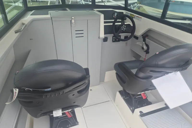 Slide: The Image of Interior of 2027 Arima Sea Ranger 21 Yellowtail Edition boat with dual seats and steering wheel. - 15