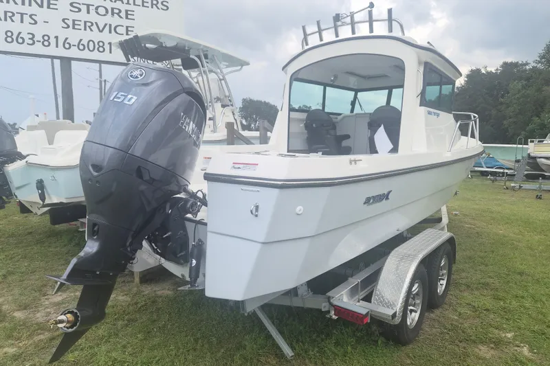 Slide: The Image of 2027 Arima Sea Ranger 21 Yellowtail Edition boat with Yamaha 150 engine on trailer. - 2