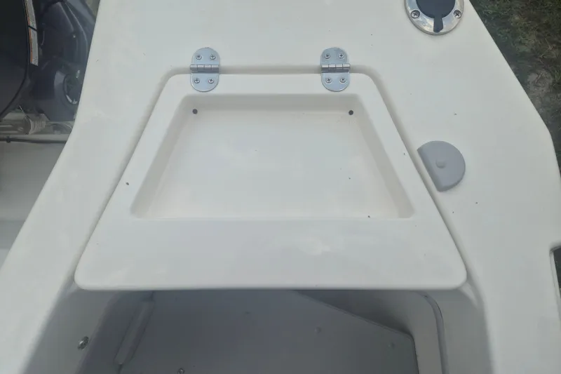 Slide: The Image of 2027 Arima Sea Ranger 21 Yellowtail Edition boat deck with storage compartment and hinges. - 5