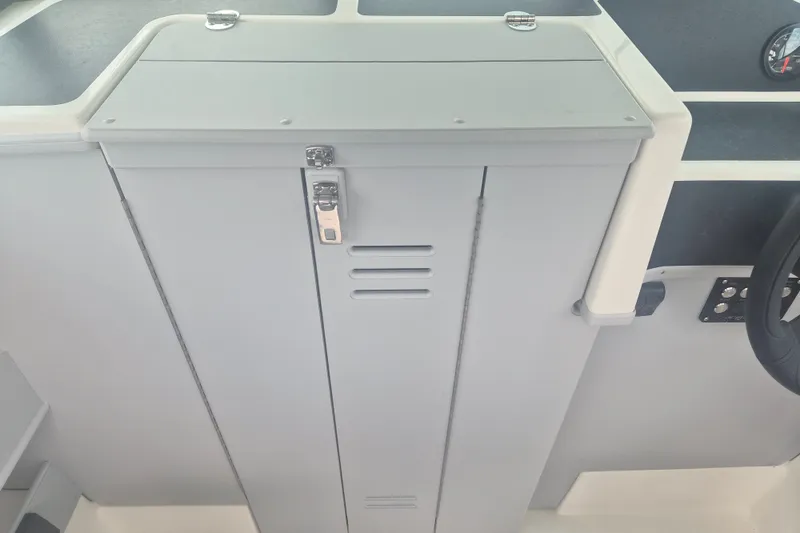 Slide: The Image of Interior view of 2027 Arima Sea Ranger 21 Yellowtail Edition boat console with storage compartment. - 22