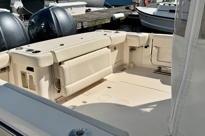 Slide: The Image of 2023 Grady-White Express 330 boat interior with seating and dual outboard motors. - 38