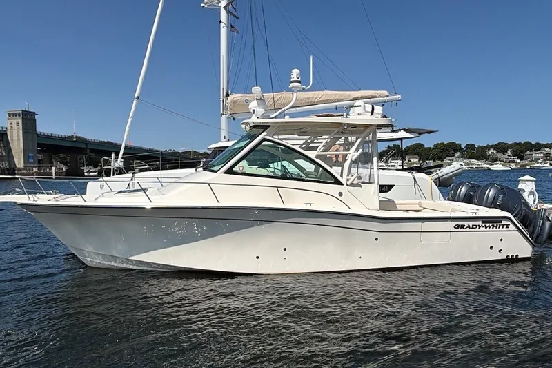 Slide: The Image of 2023 Grady-White Express 330 boat on water, showcasing sleek design and powerful engines. - 36