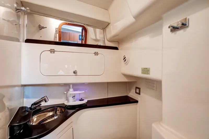 Slide: The Image of 2023 Grady-White Express 330 bathroom with sleek sink and storage cabinet. - 13