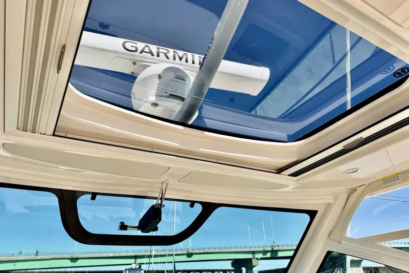 Slide: The Image of 2023 Grady-White Express 330 boat interior with Garmin equipment and sunroof view. - 26