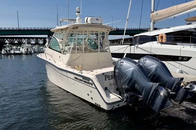 Slide: The Image of 2023 Grady-White Express 330 boat docked with twin outboard engines. - 37