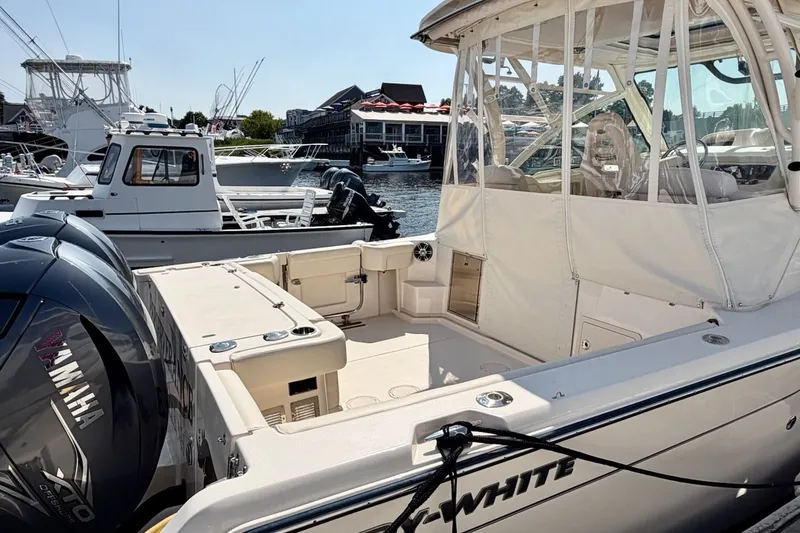Slide: The Image of 2023 Grady-White Express 330 boat docked, featuring Yamaha engines and spacious deck. - 39