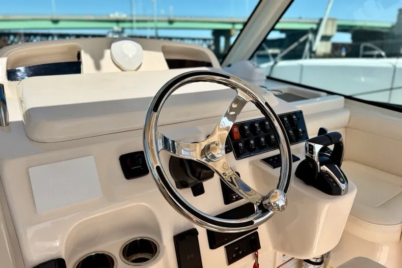 Slide: The Image of Helm of 2023 Grady-White Express 330 boat with modern controls and steering wheel. - 15