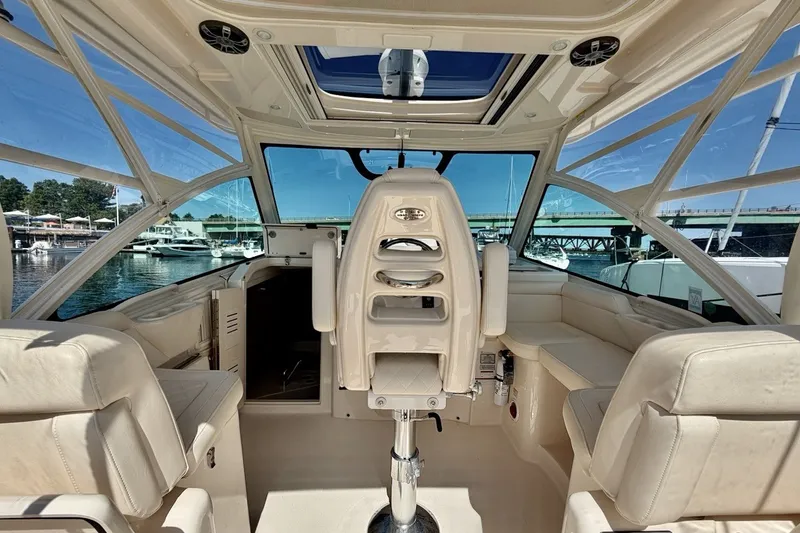 Slide: The Image of Interior view of 2023 Grady-White Express 330 boat, featuring luxurious seating and helm. - 14
