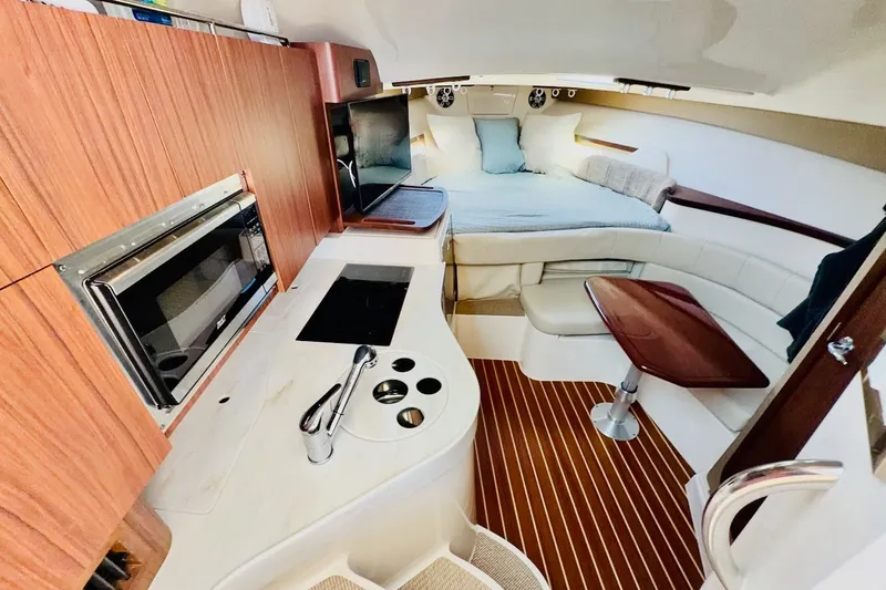 Slide: The Image of Interior of 2023 Grady-White Express 330 boat with kitchenette and cozy sleeping area. - 4