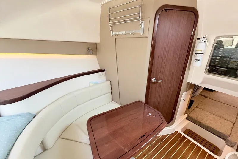 Slide: The Image of Interior of 2023 Grady-White Express 330, featuring elegant seating and wooden accents. - 9