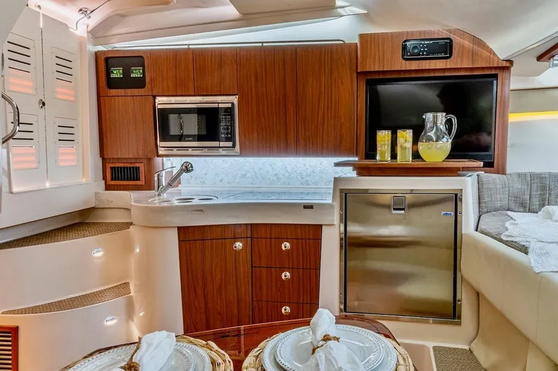 Slide: The Image of Luxurious interior of 2023 Grady-White Express 330 boat with modern kitchen amenities. - 7
