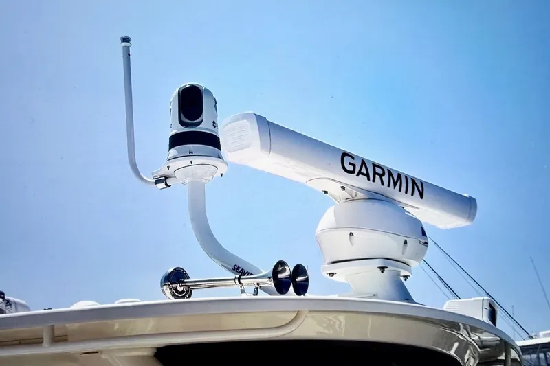 Slide: The Image of Garmin radar and camera on 2023 Grady-White Express 330 boat under clear blue sky. - 42