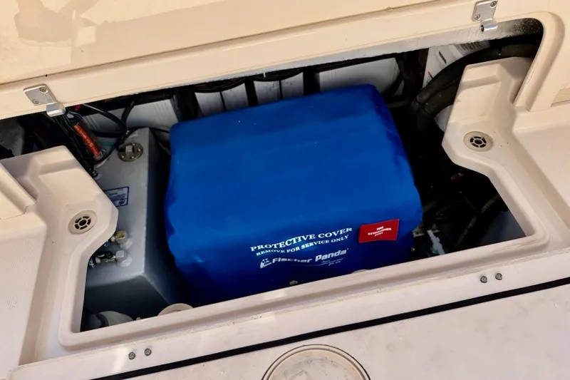 Slide: The Image of Engine compartment of 2023 Grady-White Express 330 with protective cover. - 34