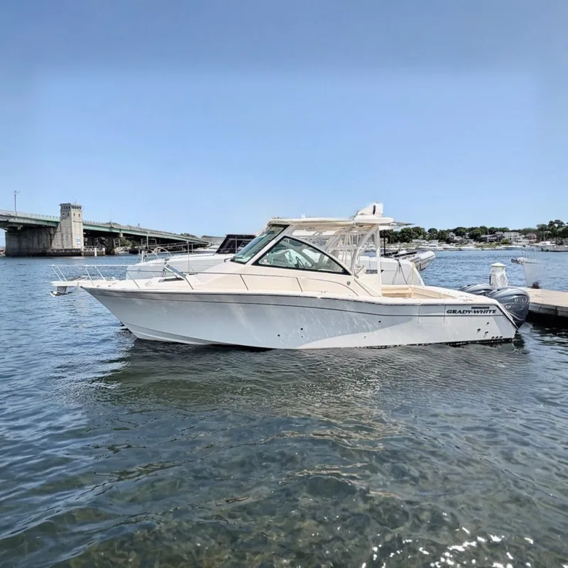 The Image of Grady-White Express 330, 2023 model, docked in the water next to a pier. - 0