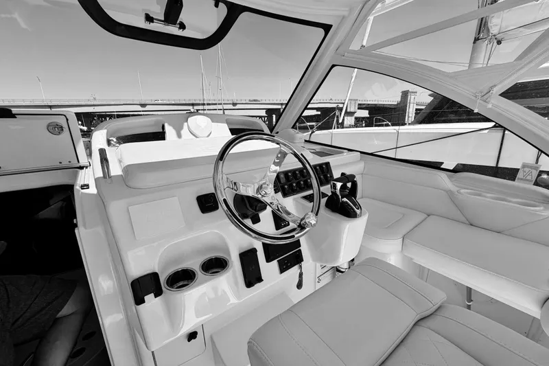 Slide: The Image of 2023 Grady-White Express 330 boat interior with steering wheel and seating area. - 16