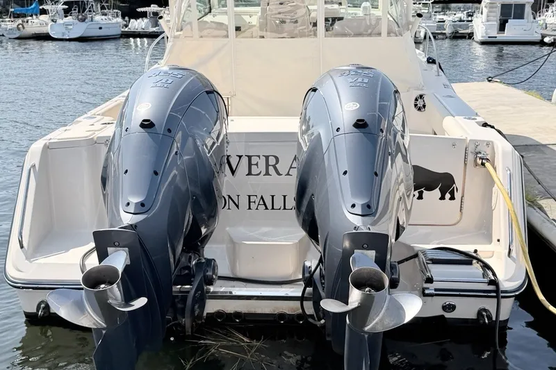 Slide: The Image of 2023 Grady-White Express 330 boat with dual outboard engines docked at marina. - 45