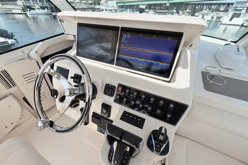 Slide: The Image of Helm of 2023 Grady-White Express 330 boat with advanced navigation displays and controls. - 20