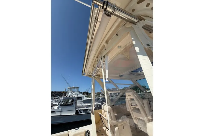 Slide: The Image of 2023 Grady-White Express 330 boat interior with clear skies and marina background. - 40