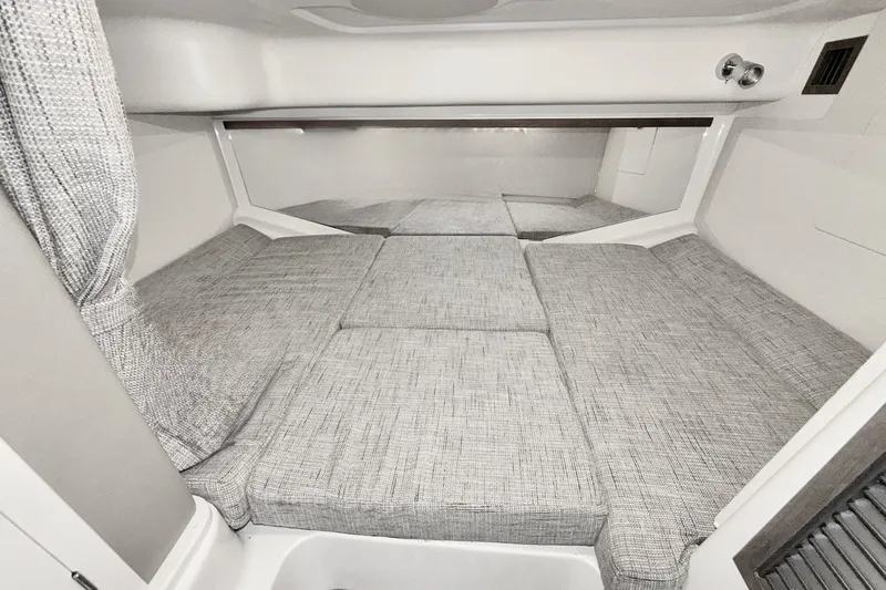 Slide: The Image of 2023 Grady-White Express 330 cabin interior with gray cushioned seating. - 11