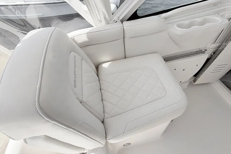 Slide: The Image of Luxurious white seating on 2023 Grady-White Express 330 boat, featuring quilted design and cup holder. - 24
