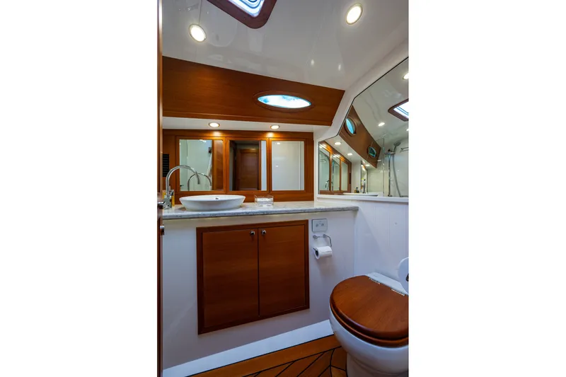 Slide: The Image of Luxurious bathroom interior of 2021 Palm Beach Motor Yachts PB55, featuring wood accents and modern fixtures. - 32