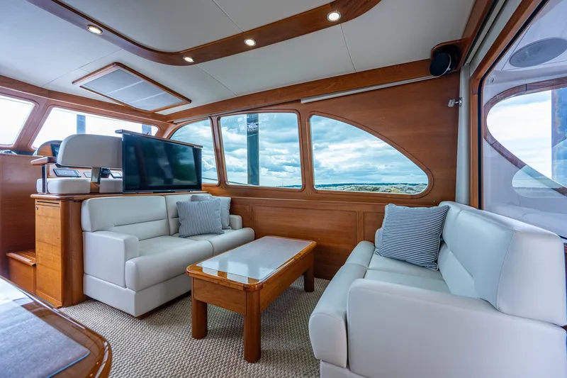 Slide: The Image of Luxurious interior of 2021 Palm Beach Motor Yachts PB55 with elegant seating and panoramic windows. - 18
