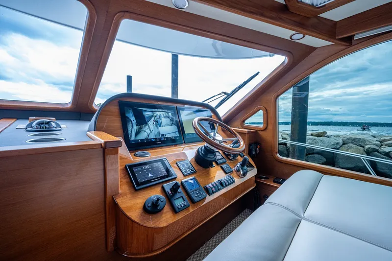 Slide: The Image of 2021 Palm Beach Motor Yachts PB55 helm with modern navigation equipment and ocean view. - 22