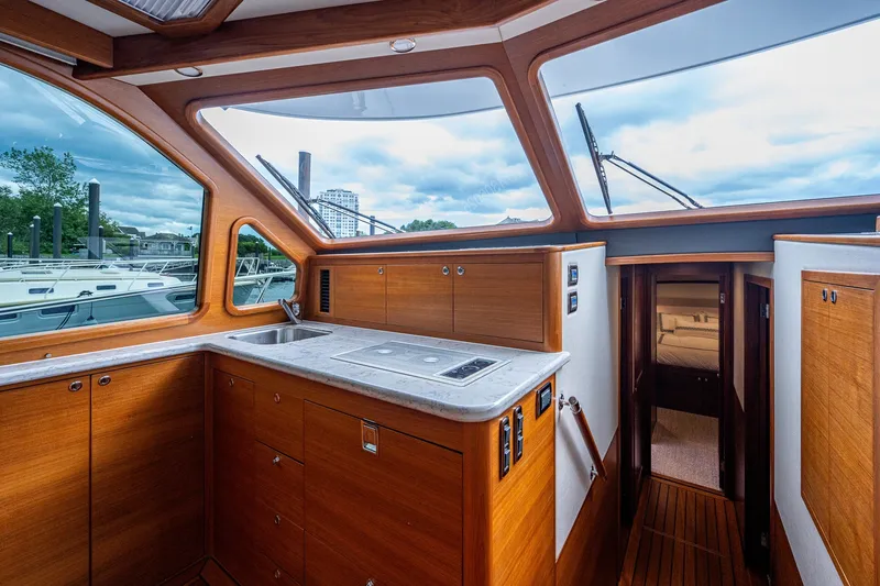 Slide: The Image of Luxurious interior of 2021 Palm Beach Motor Yachts PB55, featuring elegant wood cabinetry and modern amenities. - 24