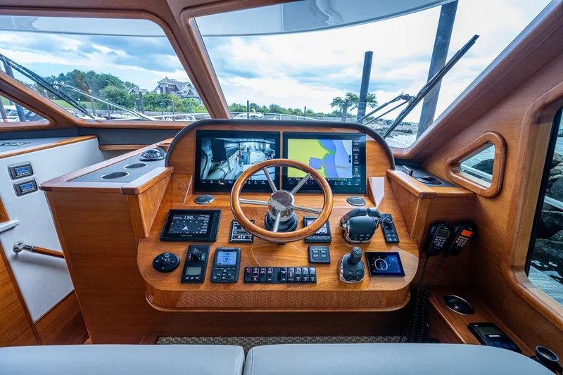 Slide: The Image of 2021 Palm Beach Motor Yachts PB55 helm with advanced navigation and control systems. - 23
