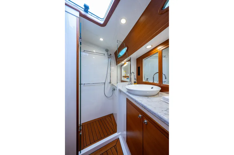 Slide: The Image of Luxurious bathroom in 2021 Palm Beach Motor Yachts PB55, featuring elegant wood and marble finishes. - 31