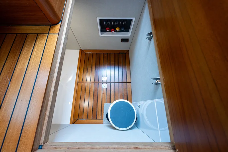 Slide: The Image of 2021 Palm Beach Motor Yachts PB55 interior with wooden flooring and storage compartment. - 36